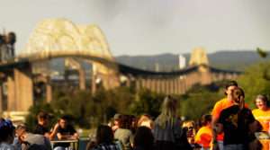 Students enjoying the beginning of the semester during LakerWeek, with the International Bridge in the background.